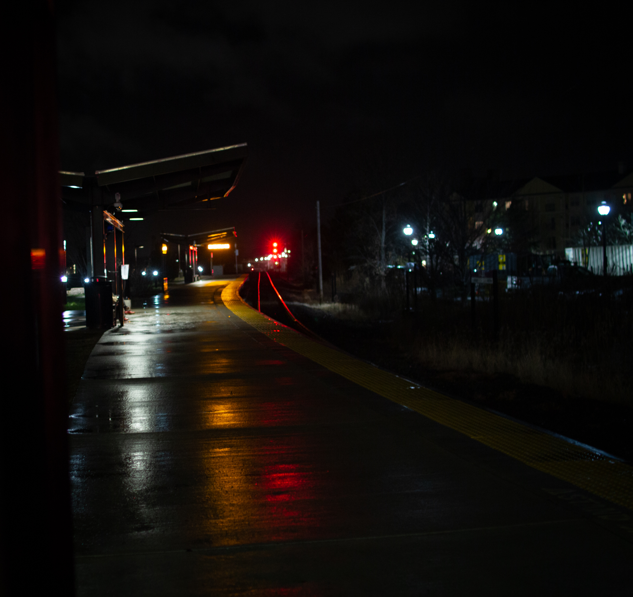 A train platform in the rain