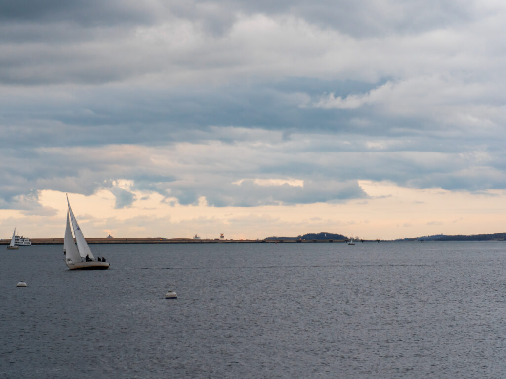 A boat on the harbor at sunset.